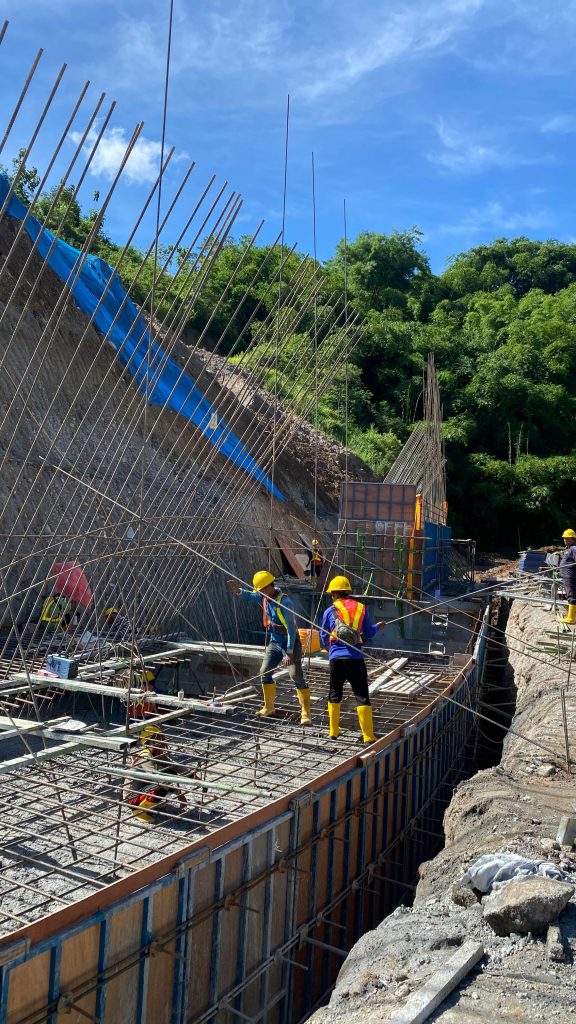 Workers busy at a sunlit construction site in Surakarta, Central Java, Indonesia.